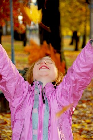 pile leaves playing - Portrait of a young girl throwing autumn leaves Stock Photo - Budget Royalty-Free & Subscription, Code: 400-04981495