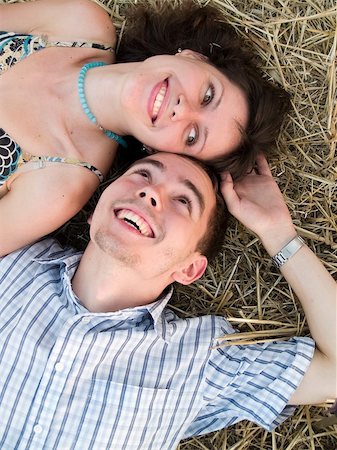 Lovely young couple lying in stray in filed Stock Photo - Budget Royalty-Free & Subscription, Code: 400-04982286