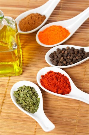 simsearch:400-03908268,k - Assortment of spices in the spoons and oil bottle for prepare tasty food with soft shadow in the wooden background. Shallow depth of field Photographie de stock - Aubaine LD & Abonnement, Code: 400-04982338