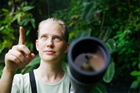 person focusing telescope - Pretty nature guide with a telescope in the rainforest Stock Photo - Budget Royalty-Free & Subscription, Code: 400-04982386