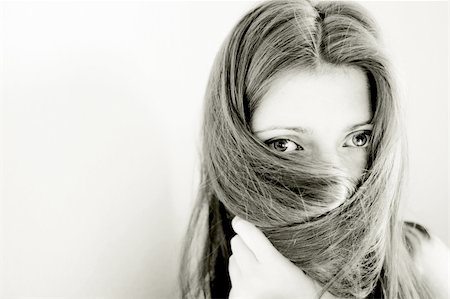 peeping fashion - young woman hiding her face with long straight brown hair Stock Photo - Budget Royalty-Free & Subscription, Code: 400-04983755