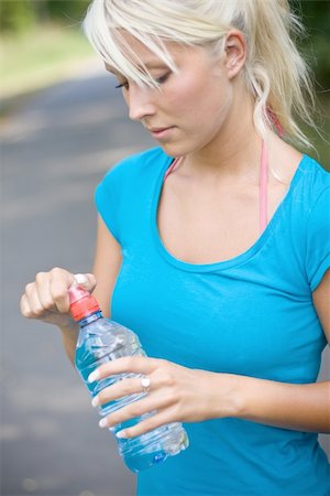 exhausted sweaty female runner - cool water after the long run Stock Photo - Budget Royalty-Free & Subscription, Code: 400-04994395
