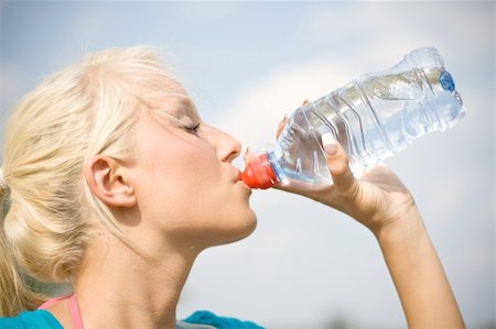 exhausted sweaty female runner - cool water after the long run Stock Photo - Budget Royalty-Free & Subscription, Code: 400-04994397