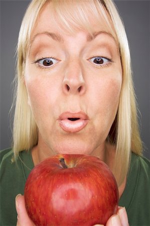 simsearch:400-04042499,k - Beautiful Woman With Apple Against A Grey Background Stock Photo - Budget Royalty-Free & Subscription, Code: 400-04995926