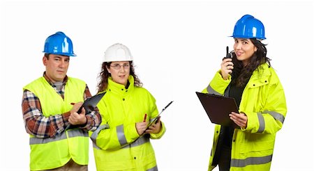 Three construction workers talking with a walkie talkie over a white background. Focus at front Stock Photo - Budget Royalty-Free & Subscription, Code: 400-04996465