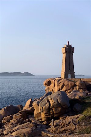 Sunset over rocks and lighthouse at Pars Kamor Ploumanach Breton Corniche Cote de Granit Rose Cotes d Armor Brittany France Europe Stock Photo - Budget Royalty-Free & Subscription, Code: 400-04997153