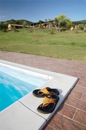 simsearch:400-05280468,k - Flip-flops on the border of the swimming-pool of a luxury country house in the famous tuscan hills, Italy. Stock Photo - Budget Royalty-Free & Subscription, Code: 400-04997729