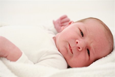 simsearch:400-07211187,k - Lying baby on white background Photographie de stock - Aubaine LD & Abonnement, Code: 400-04997801