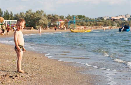 Small boy on sandy beach and sea Stock Photo - Budget Royalty-Free & Subscription, Code: 400-04997845