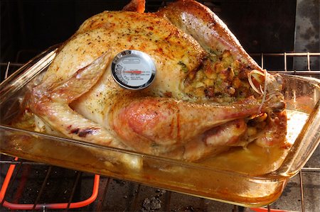 roasting thermometer - Golden Roasted Turkey in the oven with a meat thermometer. Stock Photo - Budget Royalty-Free & Subscription, Code: 400-04998608