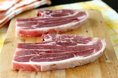 Two large cuts of raw Australian lamb cuts on a wooden chopping board in kitchen Stock Photo - Budget Royalty-Free & Subscription, Code: 400-04998693