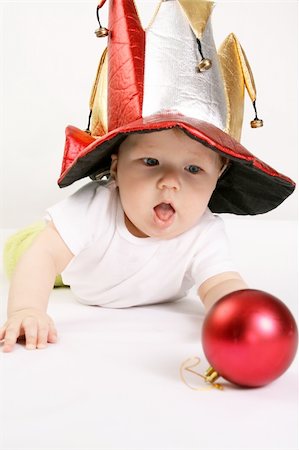 simsearch:400-05375824,k - Small boy in the hat of jester plays with the red sphere Photographie de stock - Aubaine LD & Abonnement, Code: 400-04998871