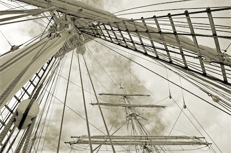 simsearch:400-04899558,k - Masts of a sailing vessel with curtailed sails. Fotografie stock - Microstock e Abbonamento, Codice: 400-04999144