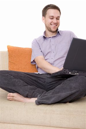 simsearch:400-04999709,k - casual man sitting on sofa with laptop Photographie de stock - Aubaine LD & Abonnement, Code: 400-04999257