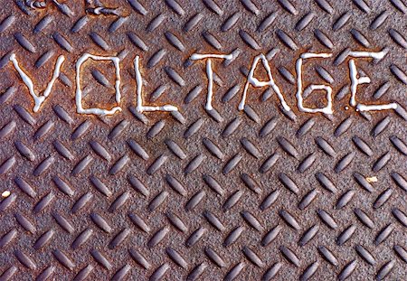 Voltage sign welded onto a manhole cover Stock Photo - Budget Royalty-Free & Subscription, Code: 400-04999409