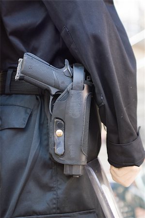police riots - policeman uniform with reglamentary gun on trousers Stock Photo - Budget Royalty-Free & Subscription, Code: 400-04999448