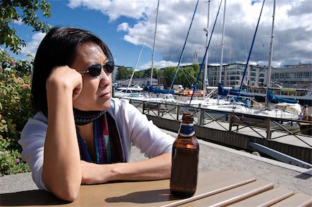 finland food - Thai woman drinking beer in a Finnish marina Stock Photo - Budget Royalty-Free & Subscription, Code: 400-04991589