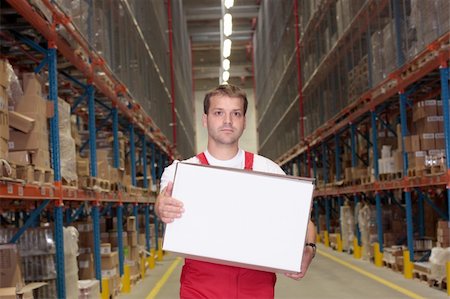 worker in uniform carrying  in warehouse Stock Photo - Budget Royalty-Free & Subscription, Code: 400-04991597