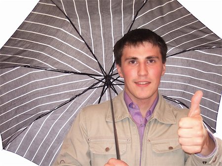 Photo of the young man under a umbrella which shows the big finger. Foto de stock - Super Valor sin royalties y Suscripción, Código: 400-04991673
