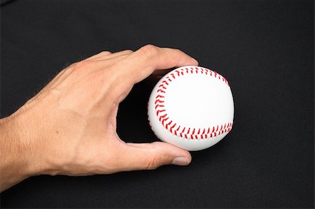 simsearch:400-04673387,k - On a black background a baseball ball in a hand Photographie de stock - Aubaine LD & Abonnement, Code: 400-04992059