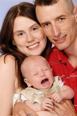 simsearch:400-04535025,k - mother, father and young baby boy posing for camera Stock Photo - Budget Royalty-Free & Subscription, Code: 400-04993365