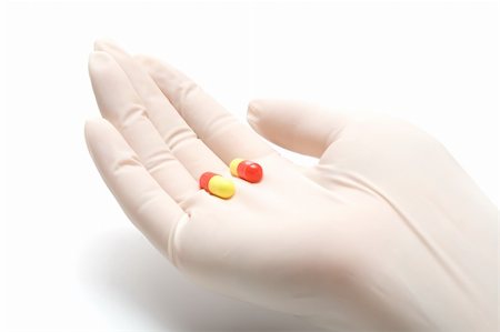 simsearch:400-04422064,k - Helping hand in latex glove giving pills, isolated, on white background Foto de stock - Super Valor sin royalties y Suscripción, Código: 400-04993844