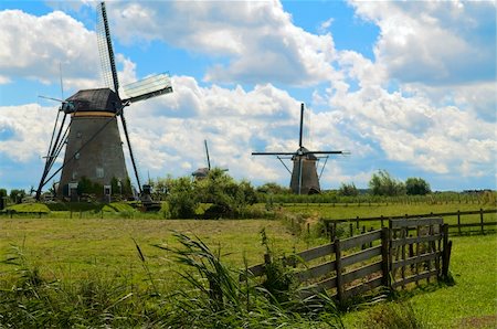 Dutch windmills in a town called Kinderdijk against a blue sky with clouds. Stock Photo - Budget Royalty-Free & Subscription, Code: 400-04993990