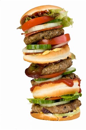 a home made quadruple hamburger isolated on white background Stock Photo - Budget Royalty-Free & Subscription, Code: 400-05004479