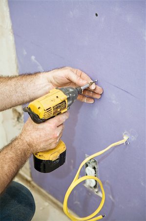drywall - Closeup of contractors hands as he uses a drill to install drywall screws. Stock Photo - Budget Royalty-Free & Subscription, Code: 400-05005000