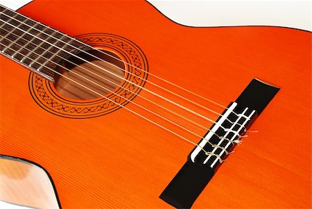 wooden orange acoustical guitar fragment over white Stock Photo - Budget Royalty-Free & Subscription, Code: 400-05005455