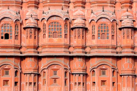 India Jaipur; hawa mahal the palace of winds; situated in the heart of the city this palace is the major attraction for tourist in rajasthan; architecture in pink sandstone with 953 windows allowing  the circulation of the breeze; this construction makes part of the city palace; the palace have the shape of the crown of the hindu god krishna Stock Photo - Budget Royalty-Free & Subscription, Code: 400-05006916