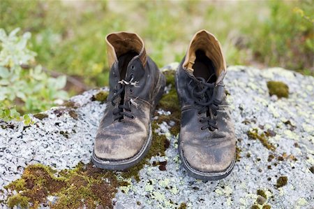 Thrown in wood, the old worn out, brown boots Stock Photo - Budget Royalty-Free & Subscription, Code: 400-05006954