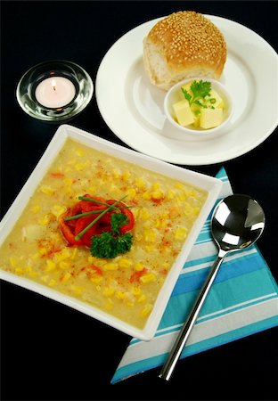 simsearch:400-04055000,k - Roasted capsicum chili and corn chowder in a dark blue table setting. Photographie de stock - Aubaine LD & Abonnement, Code: 400-05007293