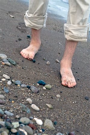 simsearch:400-04912125,k - Man's bare feet in waves on sea shore, small depth of field Stock Photo - Budget Royalty-Free & Subscription, Code: 400-05008587