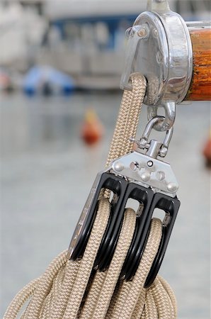 sailboat pulley - Close-up of a pulley with rope attached to boom of a sailboat Stock Photo - Budget Royalty-Free & Subscription, Code: 400-05009269