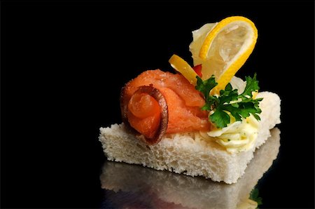 canape with smoked fish, lemon lice and parsley Stock Photo - Budget Royalty-Free & Subscription, Code: 400-05009288