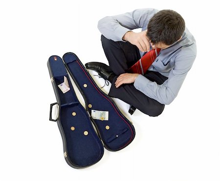 simsearch:400-04169485,k - Bankrupt businessman sitting by a violin case with some change - isolated Stock Photo - Budget Royalty-Free & Subscription, Code: 400-05009516