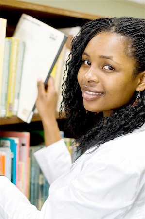 young african american college student in library searching for books Stock Photo - Budget Royalty-Free & Subscription, Code: 400-05009987