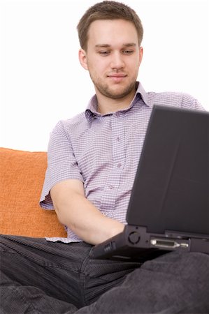 simsearch:400-04999709,k - casual guy sitting on sofa with laptop Photographie de stock - Aubaine LD & Abonnement, Code: 400-05000125