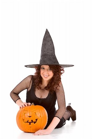 simsearch:400-04007612,k - Portrait of Latina teenager girl in black Halloween hat and fishnet dress with carved pumpkin (Jack O' Lantern) (focus on pumpkin) Stock Photo - Budget Royalty-Free & Subscription, Code: 400-05001108