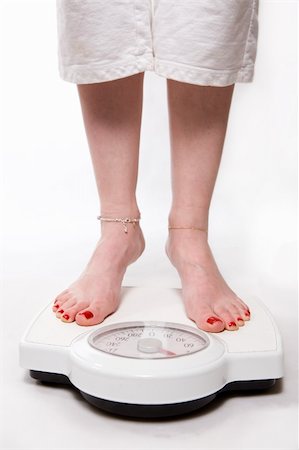 standing on toes - Legs of a woman with painted red toe nails standing on a bathroom scale Stock Photo - Budget Royalty-Free & Subscription, Code: 400-05001747