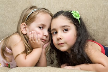 simsearch:400-05352235,k - two cute little girls lying on the sofa Photographie de stock - Aubaine LD & Abonnement, Code: 400-05002145