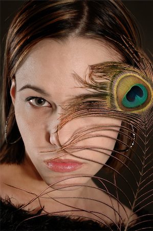 simsearch:400-05092676,k - Portrait of female beauty holding peacok feather by her face Stock Photo - Budget Royalty-Free & Subscription, Code: 400-05002240