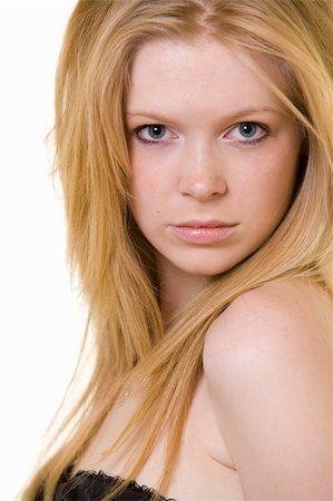 simsearch:400-04498992,k - Attractive close up of face of a woman with long blond hair and blue eyes with serious expression over white Photographie de stock - Aubaine LD & Abonnement, Code: 400-05002787