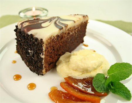 Rich chocolate cake with orange toffee and cream with a mint garnish. Stock Photo - Budget Royalty-Free & Subscription, Code: 400-05002830