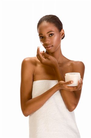 simsearch:400-05001102,k - Beautiful young ethnic woman with Slicked Back Hair wrapped in white bath towel applying moisturizer on her face Photographie de stock - Aubaine LD & Abonnement, Code: 400-05003078