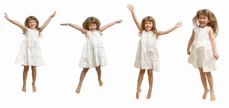 The Small girl in white gown spins, jumps, playing, smiling,  pose on white background. Fotografie stock - Microstock e Abbonamento, Codice: 400-05014240