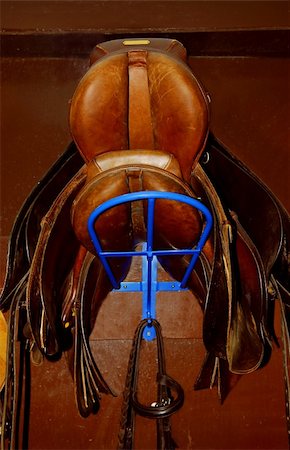 simsearch:600-06334600,k - Two saddles on a rack in a tack room, horseback riding equipment Stockbilder - Microstock & Abonnement, Bildnummer: 400-05014416