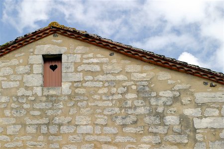 Traditional Charente-style house with a wooden attic door Stock Photo - Budget Royalty-Free & Subscription, Code: 400-05014676