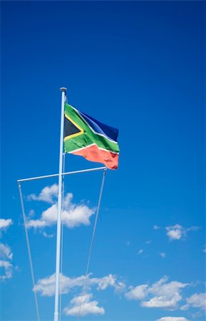 skyscaper and africa - 2010 will be the year of the world cup of soccer in south africa. Here a beautiful flag on a vivid blue cloudy sky Stock Photo - Budget Royalty-Free & Subscription, Code: 400-05014730